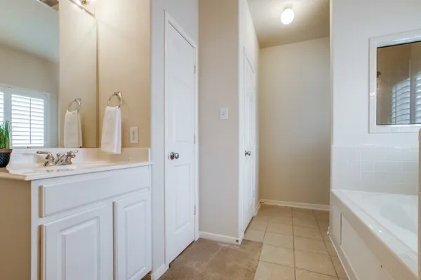 an empty room with windows and ceiling fan
