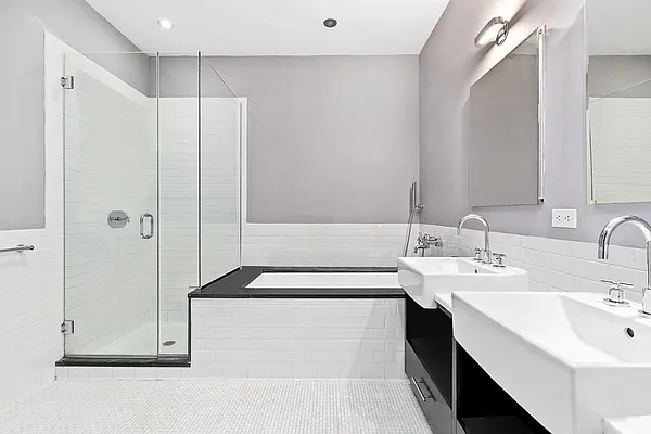 110 Livingston Street, Unit 17K Brooklyn, NY 11201 - Photo 5 of 11 a bathroom with a double vanity sink a mirror and a shower