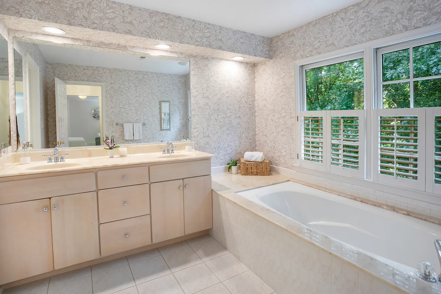 a bathroom with a tub sink and mirror