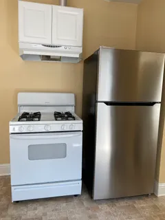 a view of a stove top oven and refrigerator