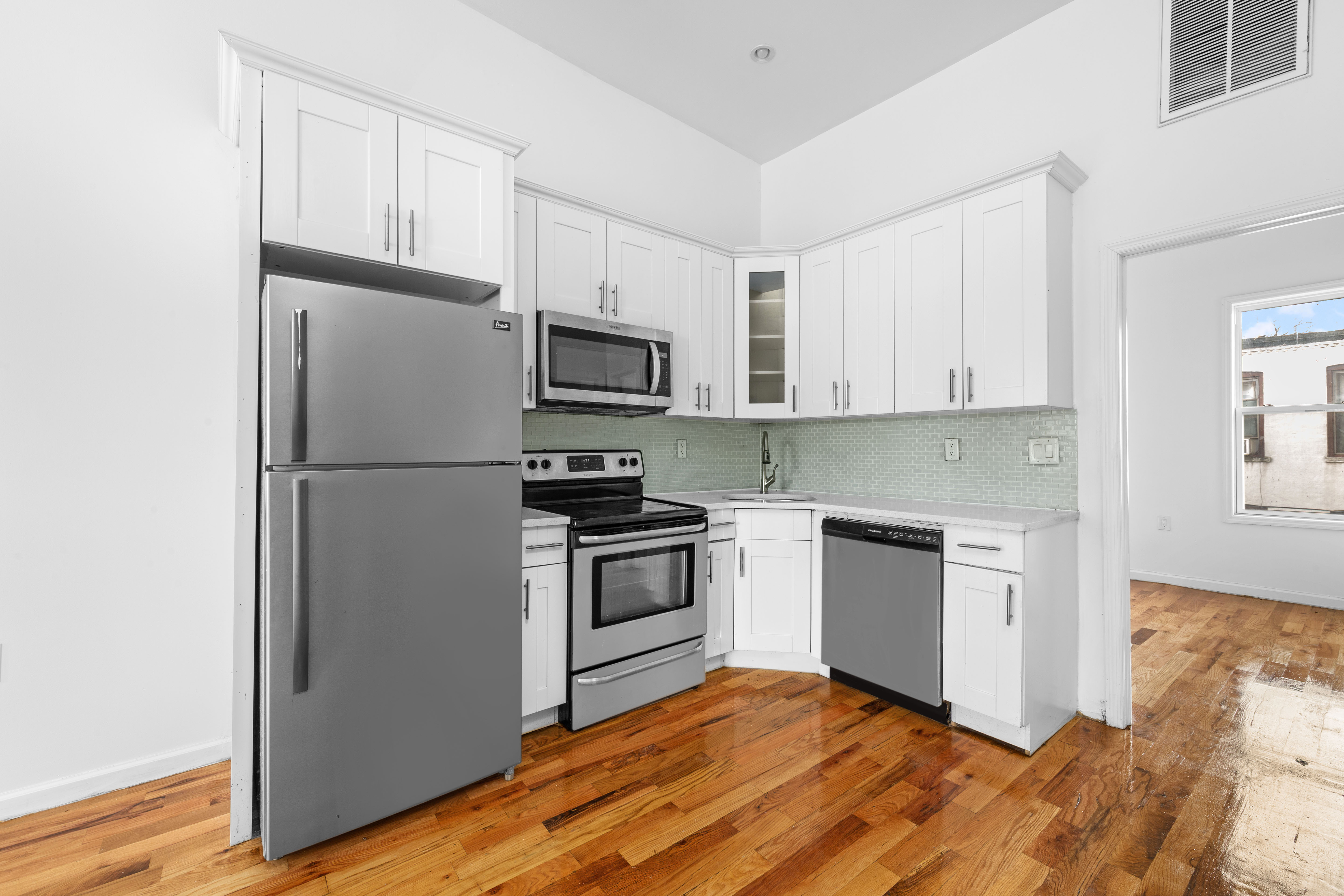 2311 Cortelyou Road Brooklyn, NY 11226 - Photo 7 of 10 a kitchen with a refrigerator cabinets and wooden floor