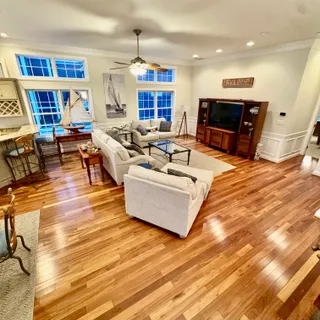 a living room with furniture and a wooden floor