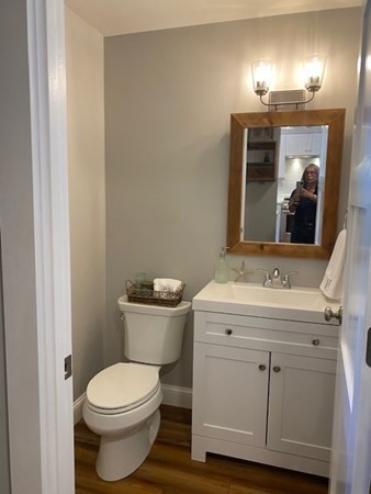 10 Beal's Cove Road, Unit E Hingham, MA 02043 - Photo 3 of 12 a bathroom with a toilet sink and mirror