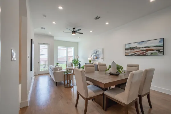 a view of a dining room with furniture and wooden floor