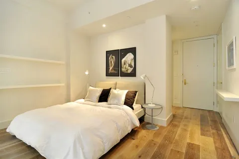 a bedroom with a bed and a rug