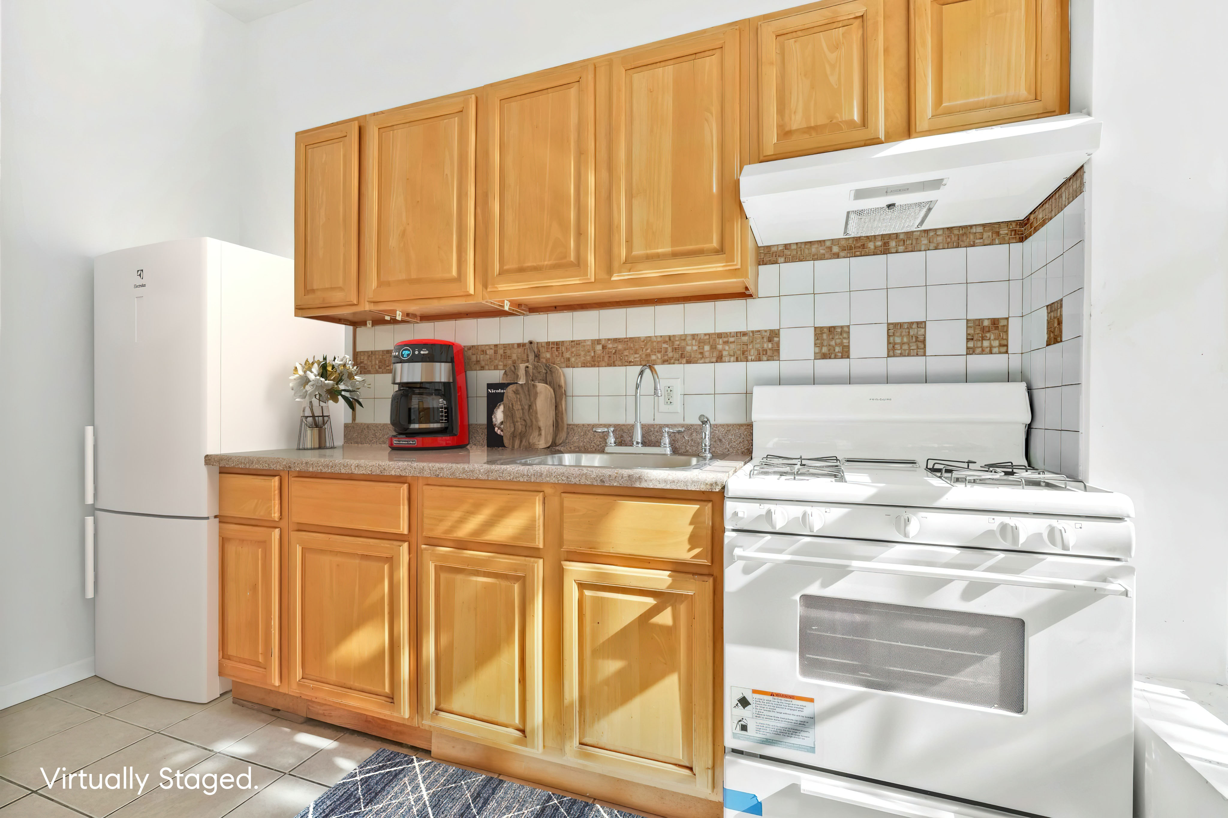 238 Vernon Avenue, Unit 2 Brooklyn, NY 11206 - Photo 10 of 21 a kitchen with stainless steel appliances granite countertop a stove a sink and a refrigerator