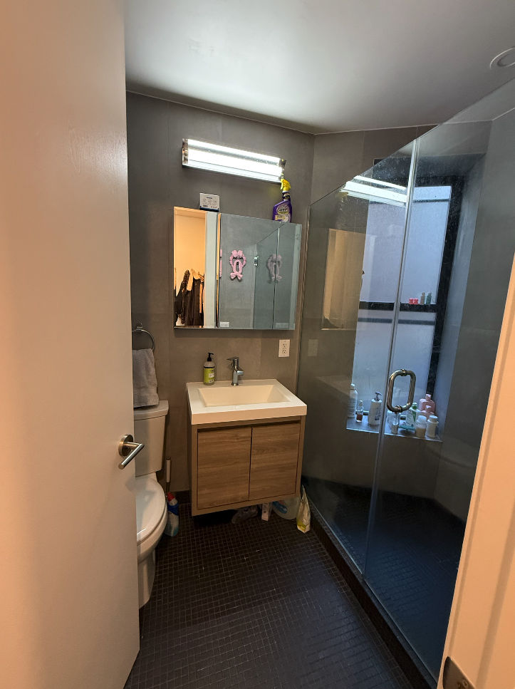 34 Carmine Street, Unit 2D Manhattan, NY 10014 - Photo 7 of 8 a bathroom with a sink and mirror with bathtub