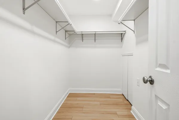 a view of a hallway with white walls and stairs