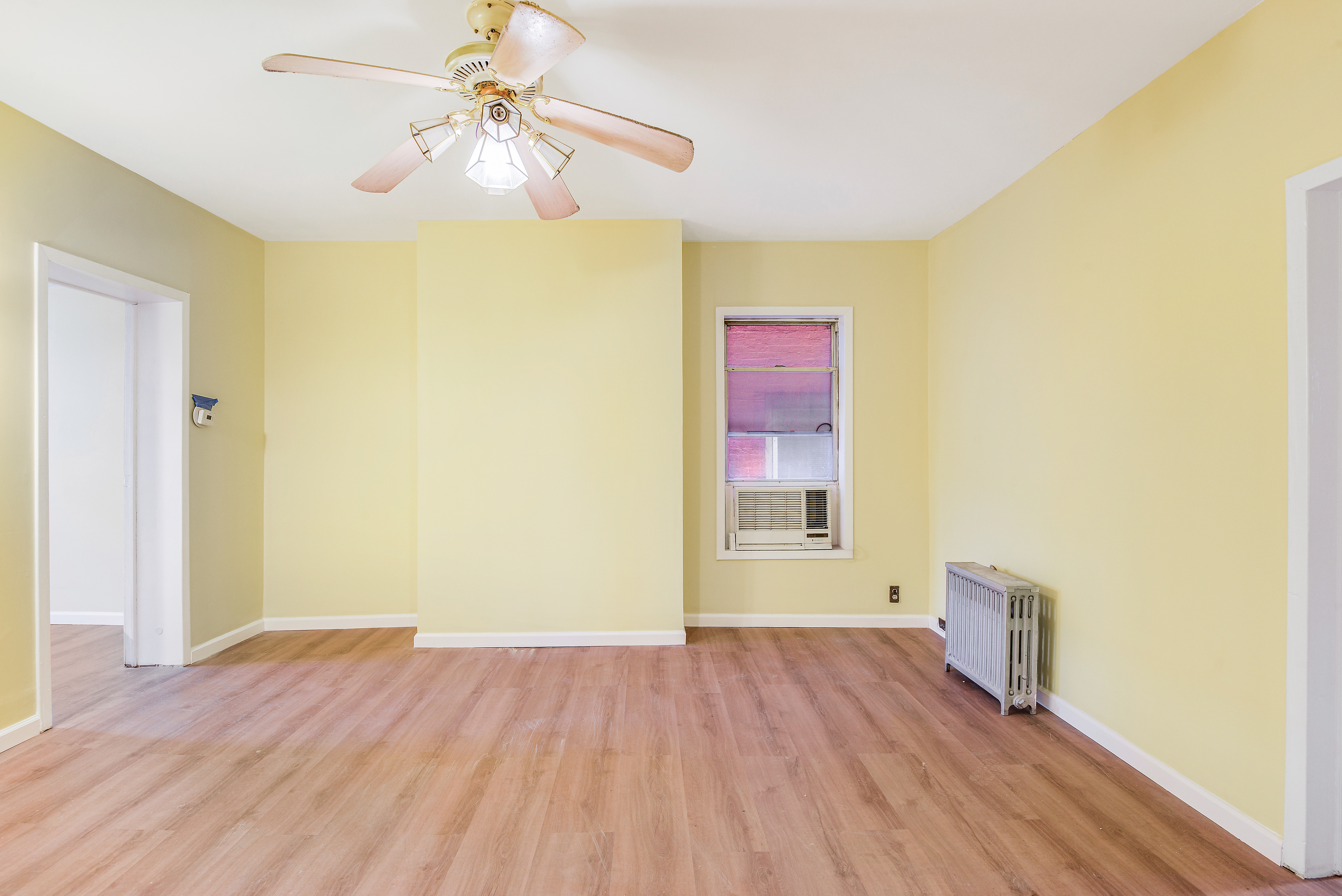 35-47 30th Street, Unit 1 Queens, NY 11106 - Photo 3 of 15 a view of a room with wooden floor and a ceiling fan