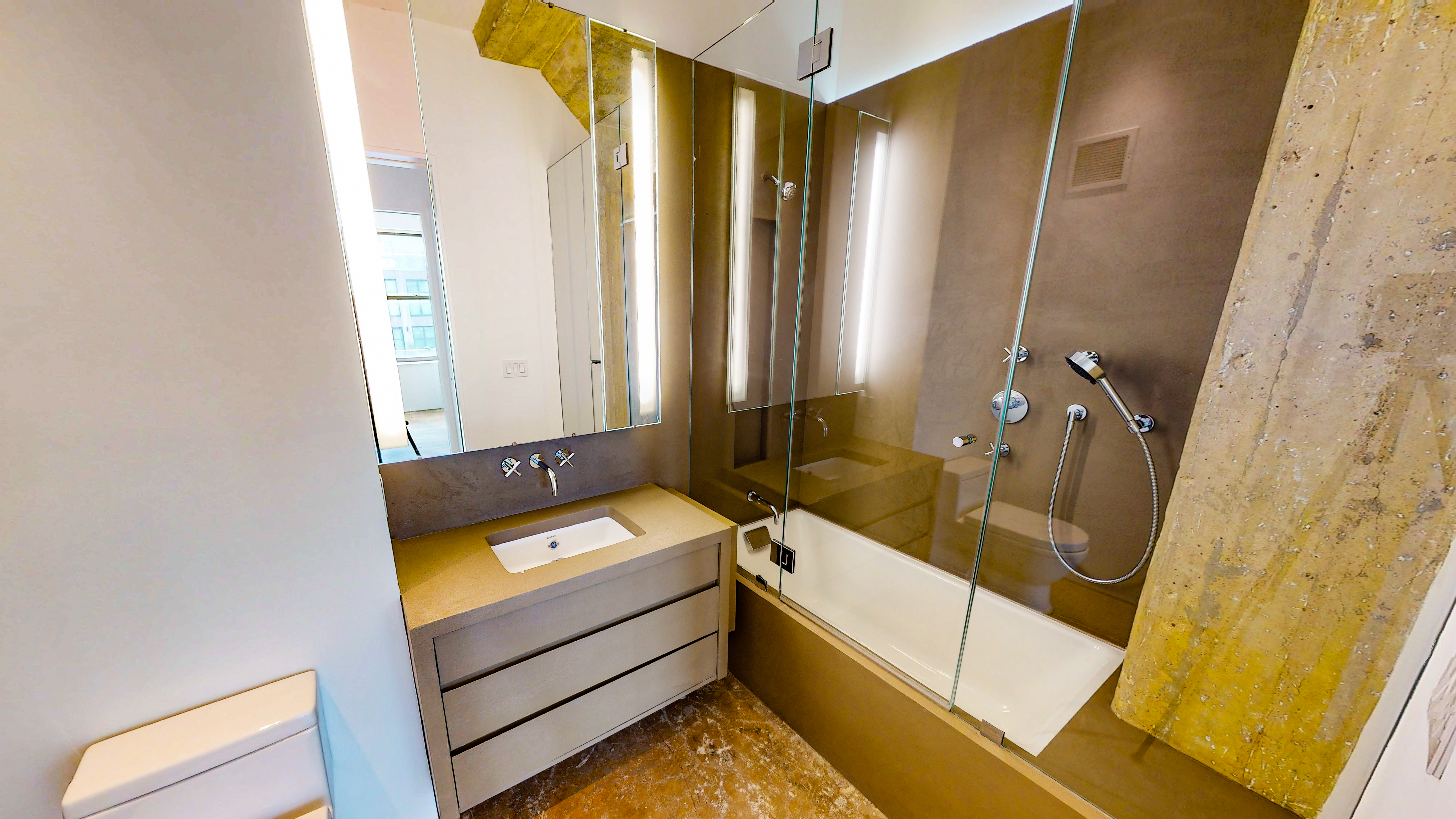 25 North Moore Street, Unit 10B Manhattan, NY 10013 - Photo 8 of 15 a bathroom with a tub sink and mirror