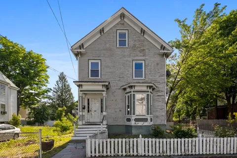 a kitchen with a refrigerator and a stove top oven