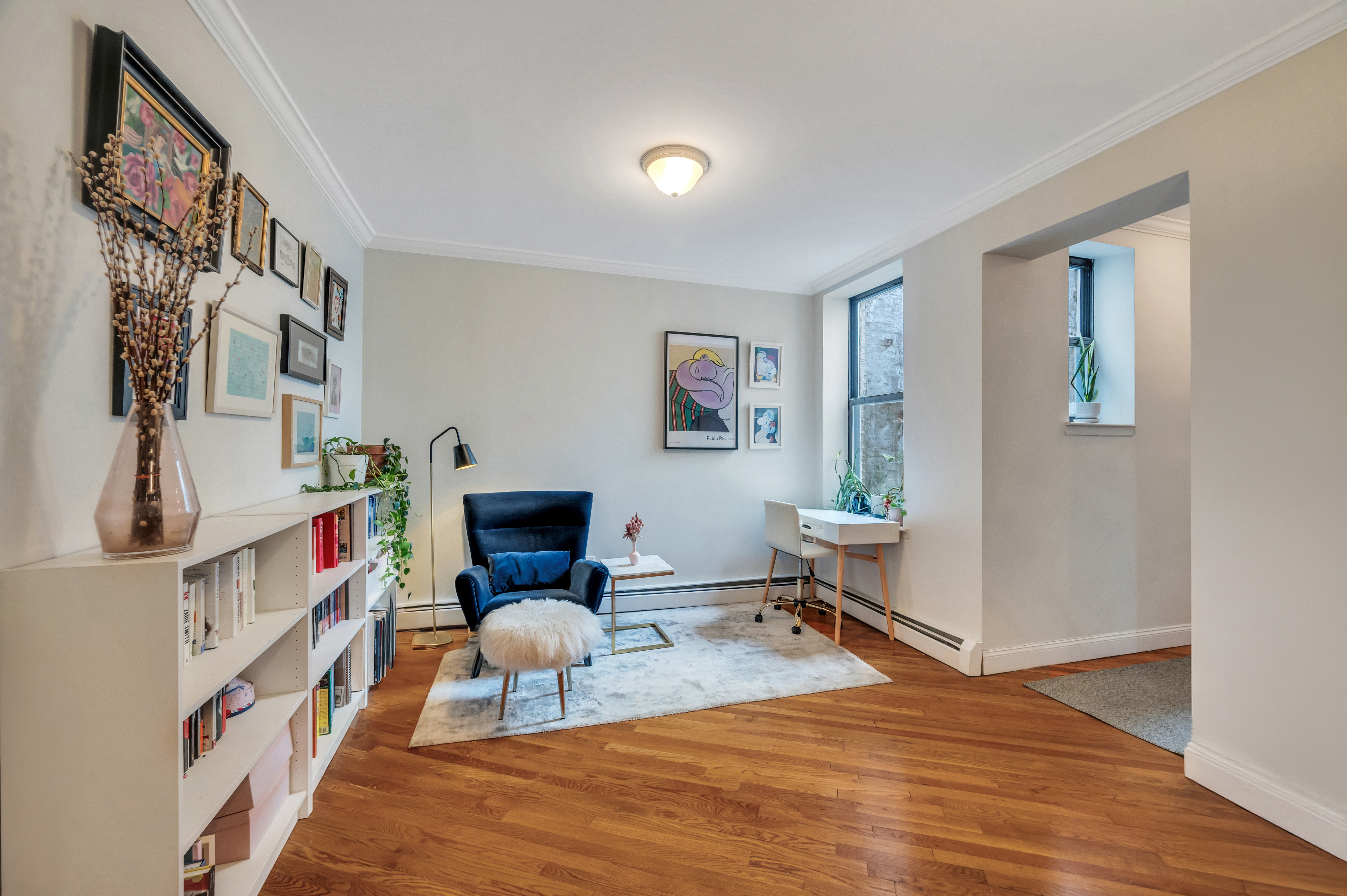120 2nd Avenue, Unit 5A Manhattan, NY 10003 - Photo 5 of 13 a living room with furniture and a book shelf
