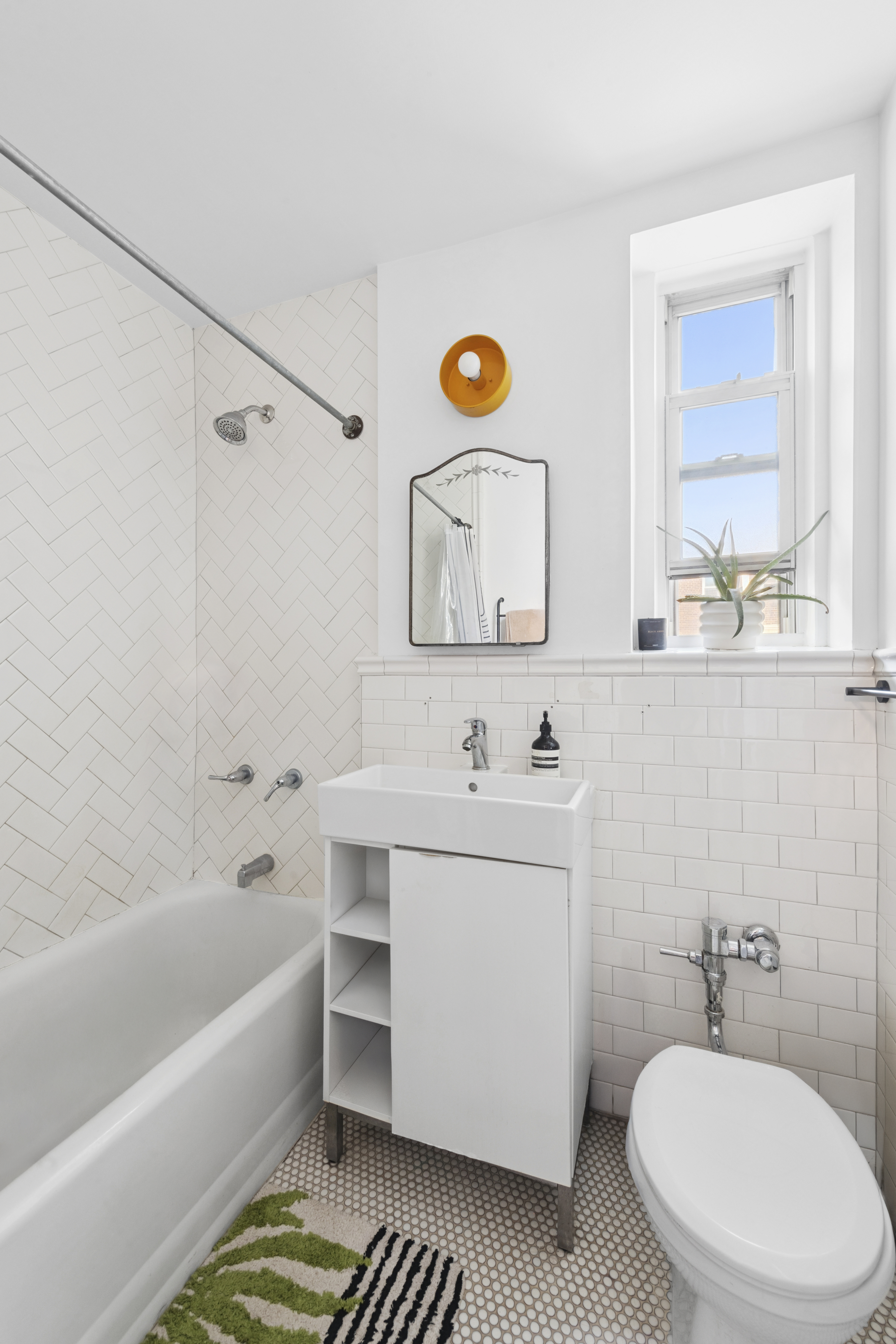 140 East 2nd Street, Unit 5F Brooklyn, NY 11218 - Photo 6 of 7 a bathroom with a sink a toilet and shower