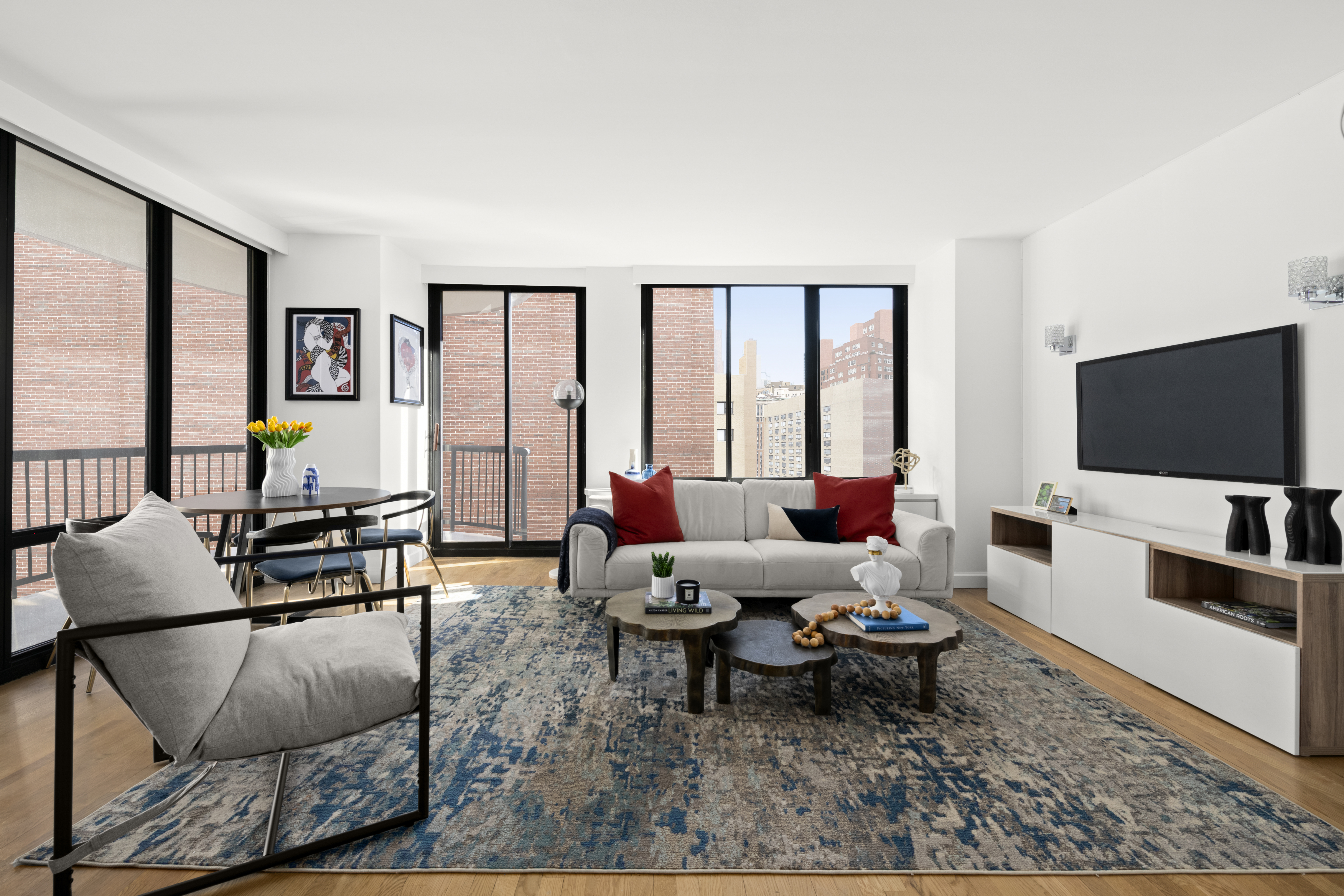 304 East 65th Street, Unit 6D Manhattan, NY 10065 - Photo 1 of 15 a living room with furniture and a flat screen tv