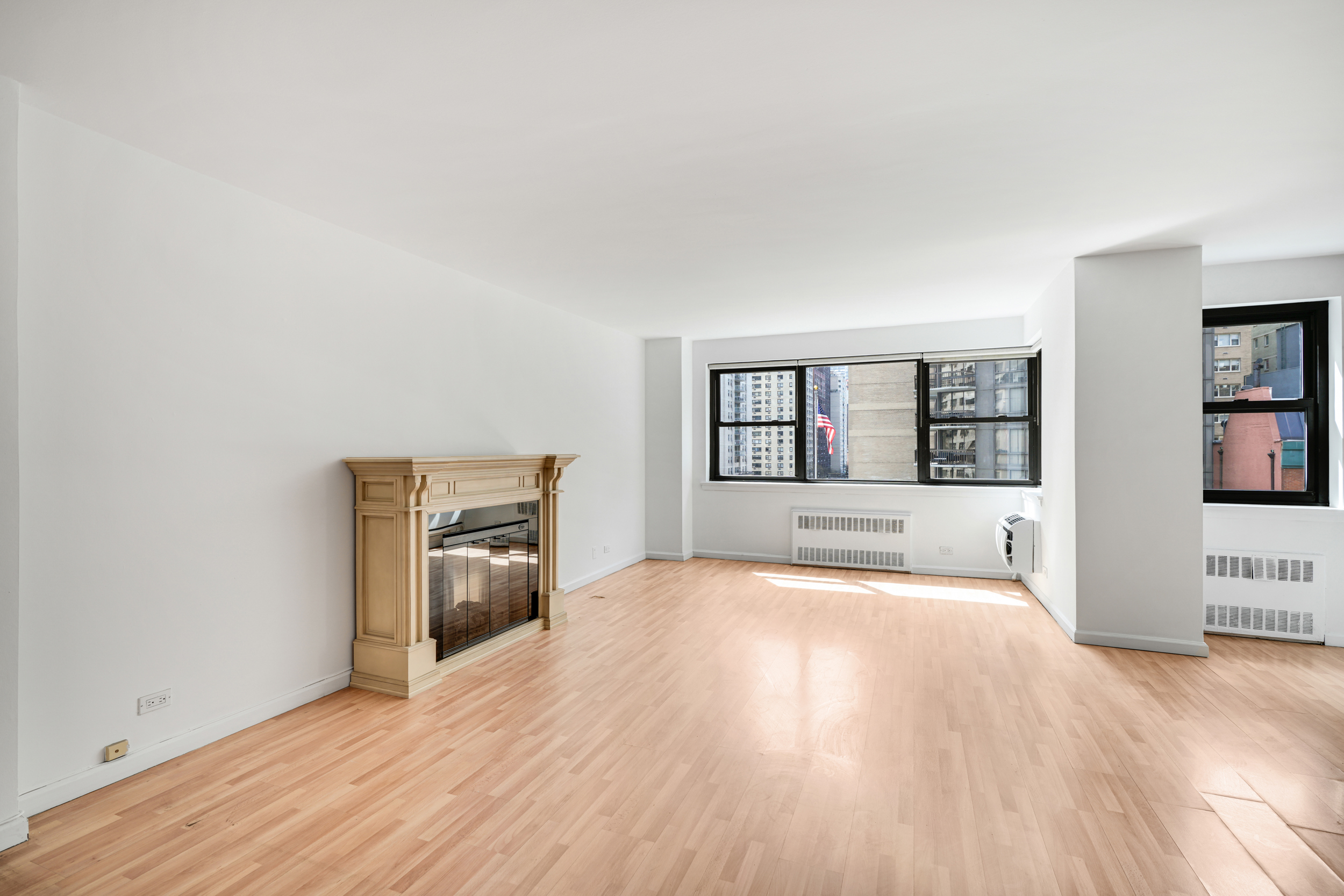 357 East 57th Street, Unit 5D Manhattan, NY 10022 - Photo 4 of 23 a view of an empty room with a window and wooden floor