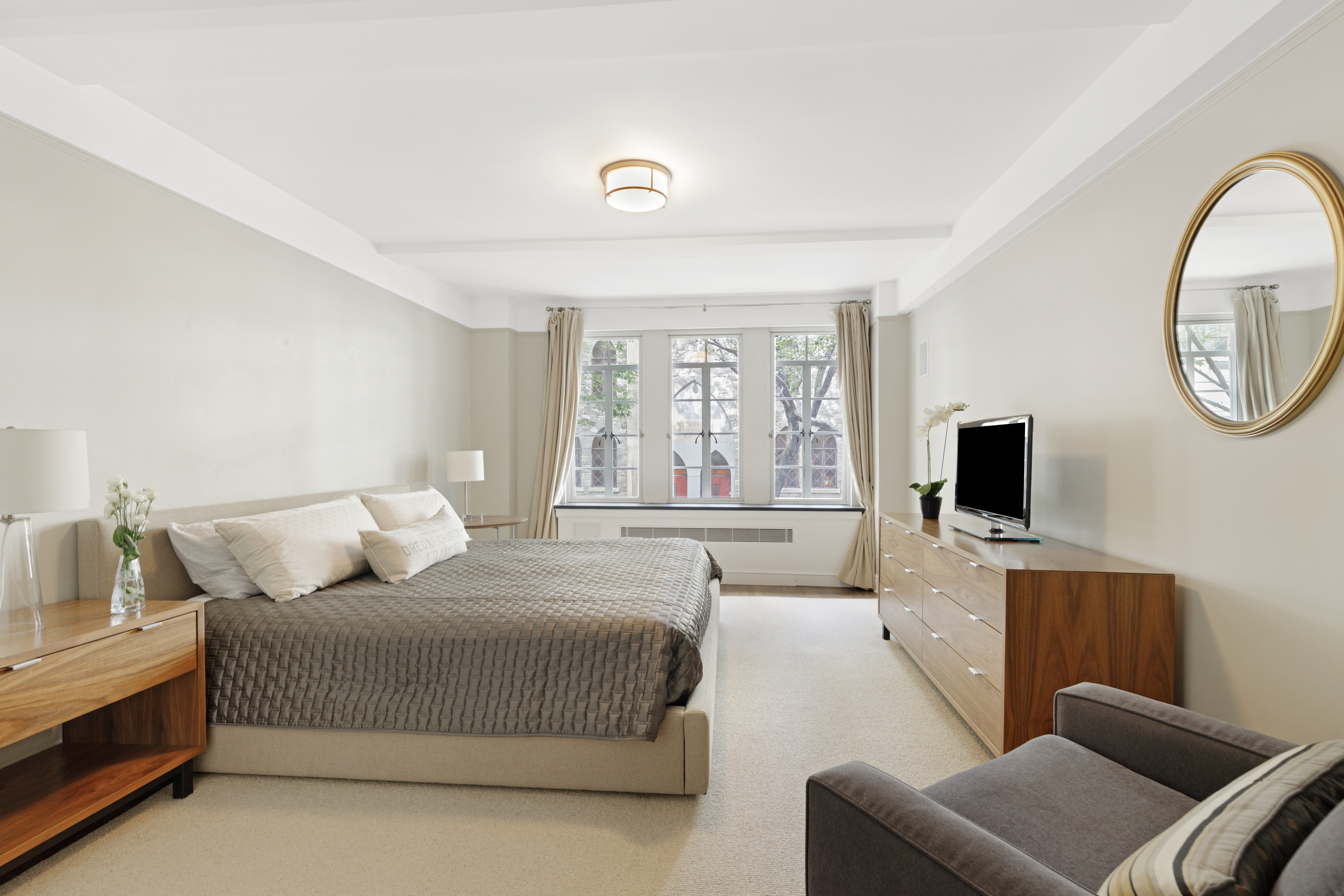 110 East 87th Street, Unit 2C Manhattan, NY 10128 - Photo 7 of 12 a living room with furniture and a flat screen tv