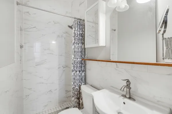 a bathroom with a shower curtain and a sink