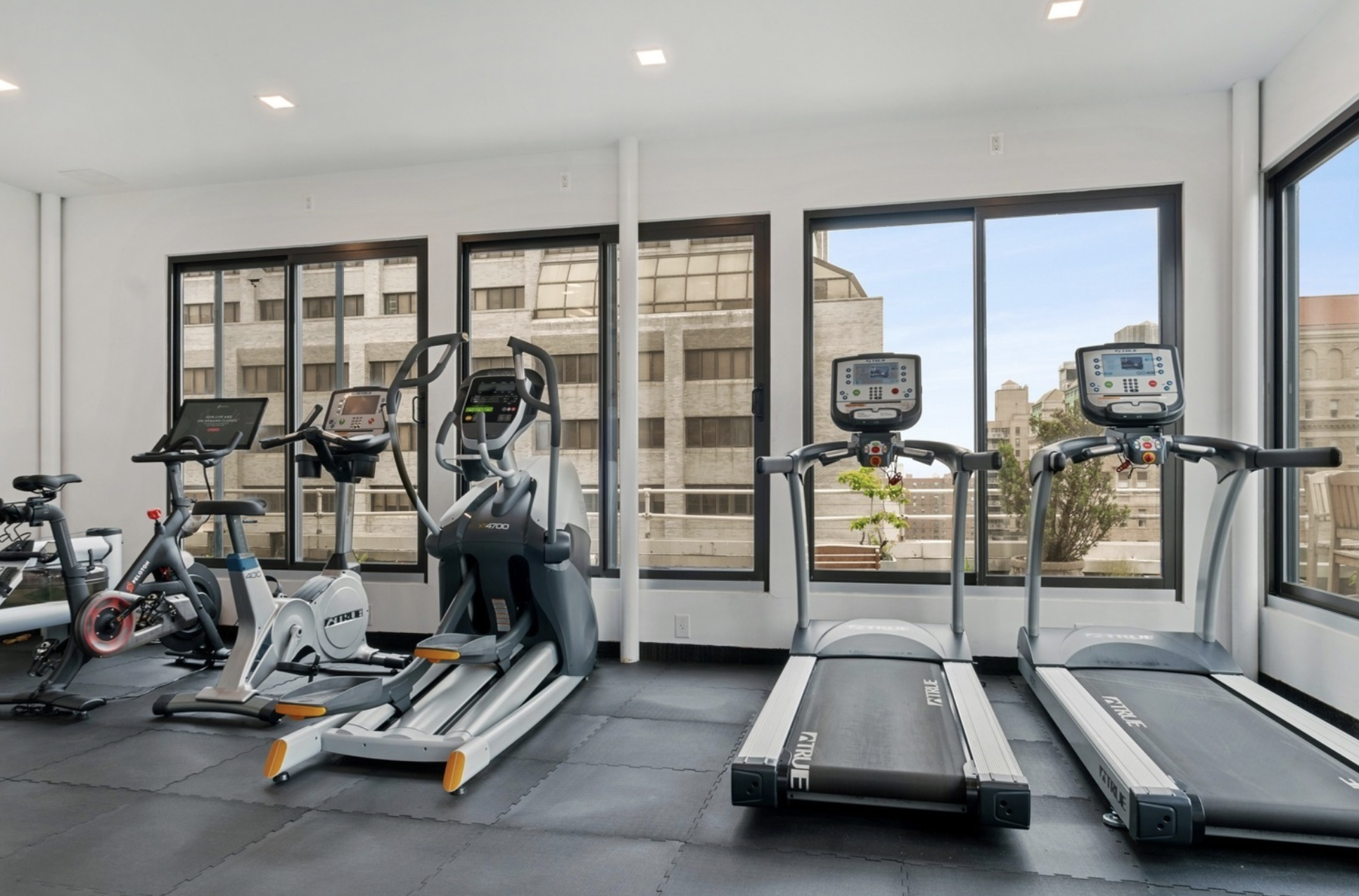 305 2nd Avenue, Unit 325 Manhattan, NY 10003 - Photo 15 of 22 a room with gym equipment and large mirror