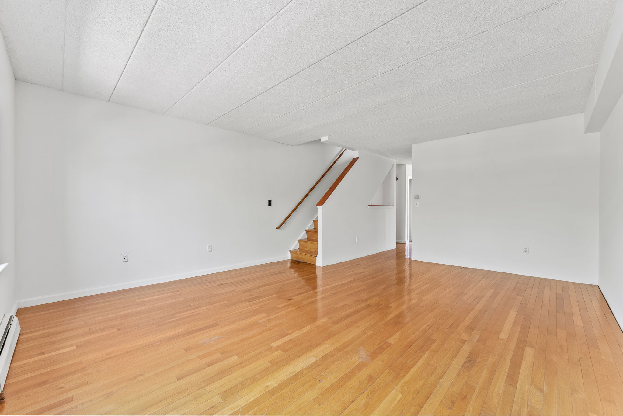 2573 Frederick Douglass Boulevard, Unit D Manhattan, NY 10030 - Photo 6 of 13 a view of an empty room with wooden floor