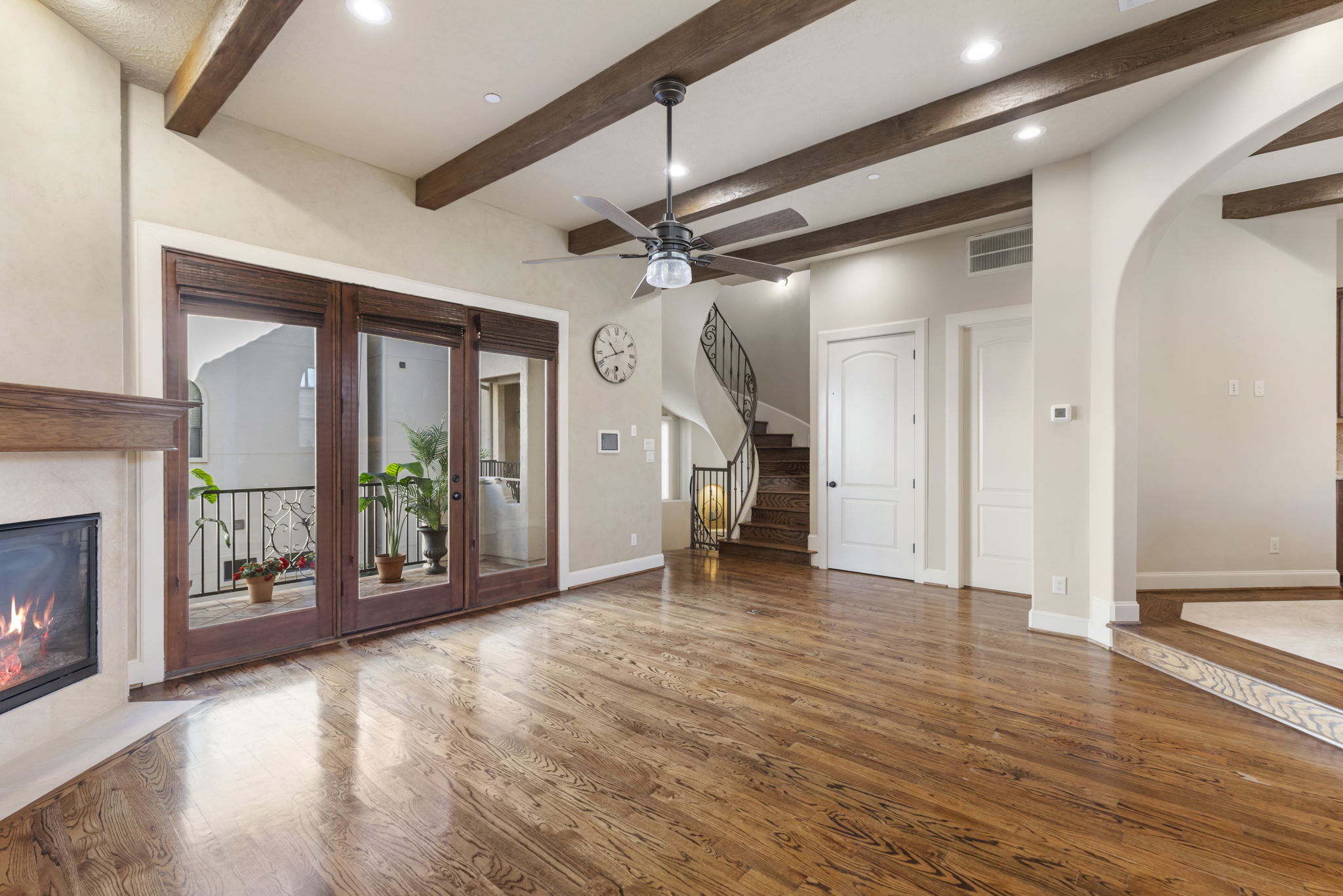 5407 Feagan Street Houston, TX 77007 - Photo 5 of 43 a view of a livingroom with wooden floor a fireplace a chandelier and windows