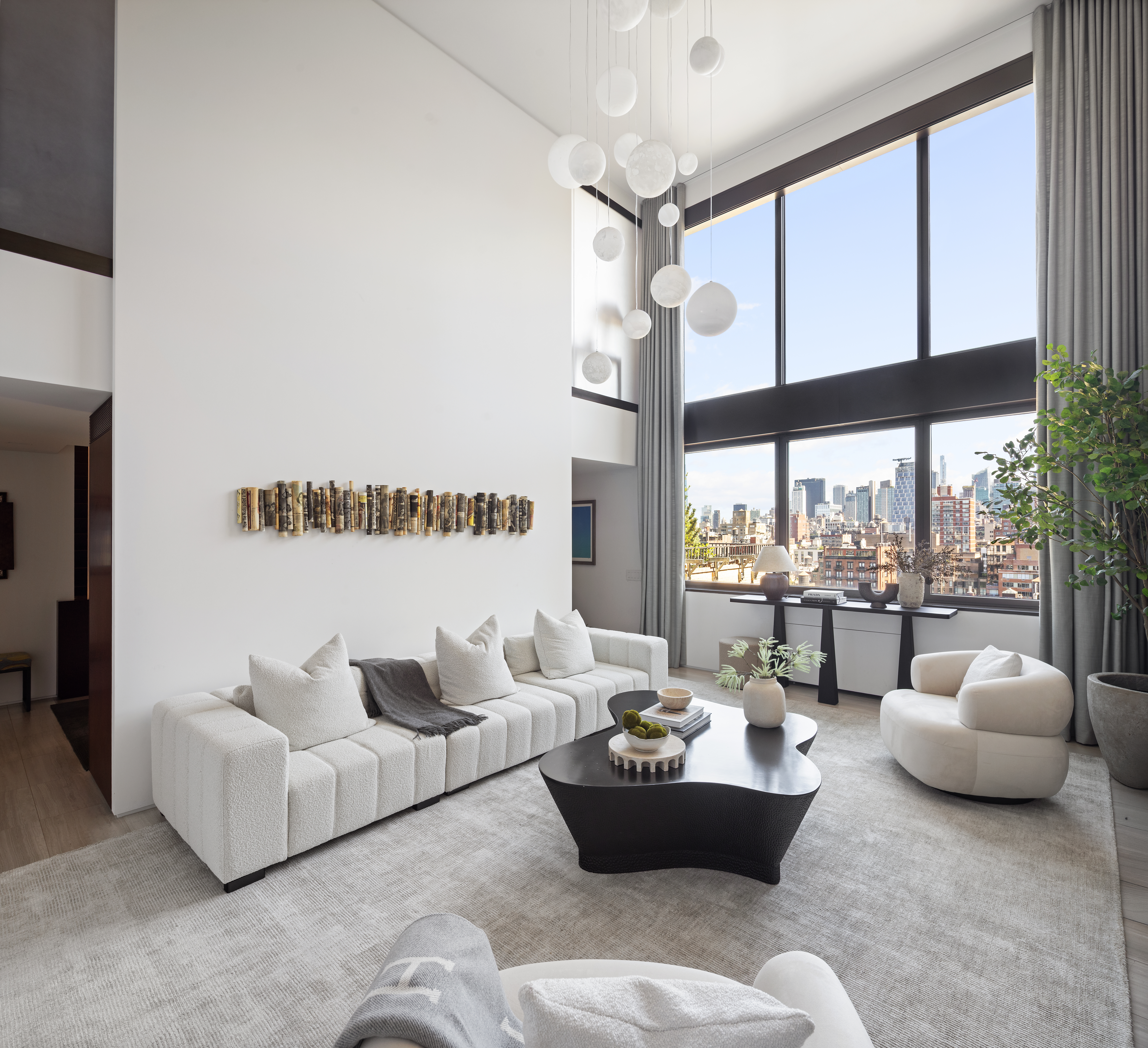 24 5th Avenue, Unit PH1701 Manhattan, NY 10011 - Photo 6 of 24 a living room with furniture and a large window