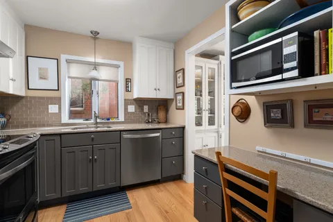 a kitchen with stainless steel appliances granite countertop a stove and a microwave