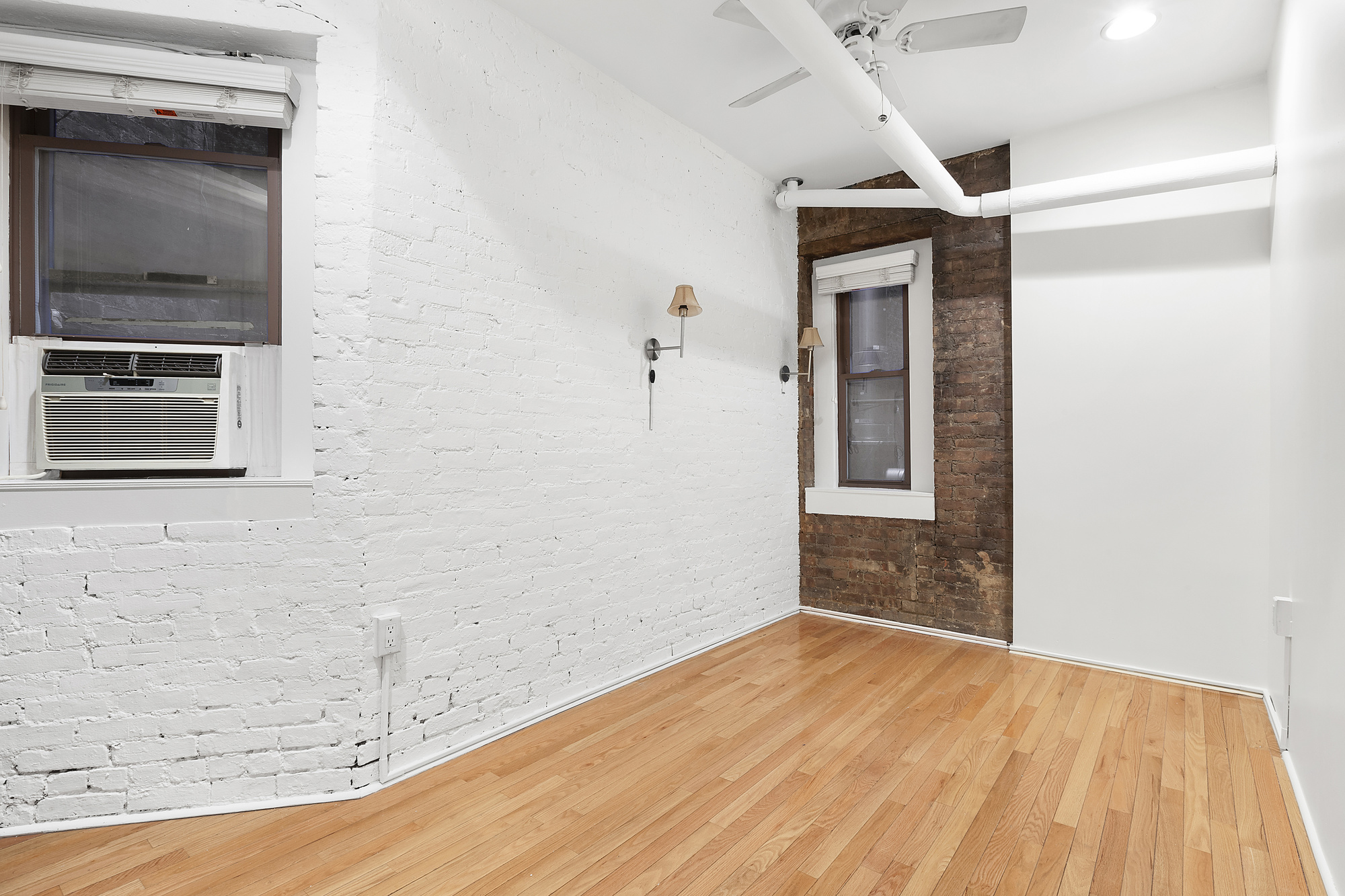 140 West 10th Street, Unit BTE Manhattan, NY 10014 - Photo 5 of 12 a view of a hallway with wooden floor and a fireplace