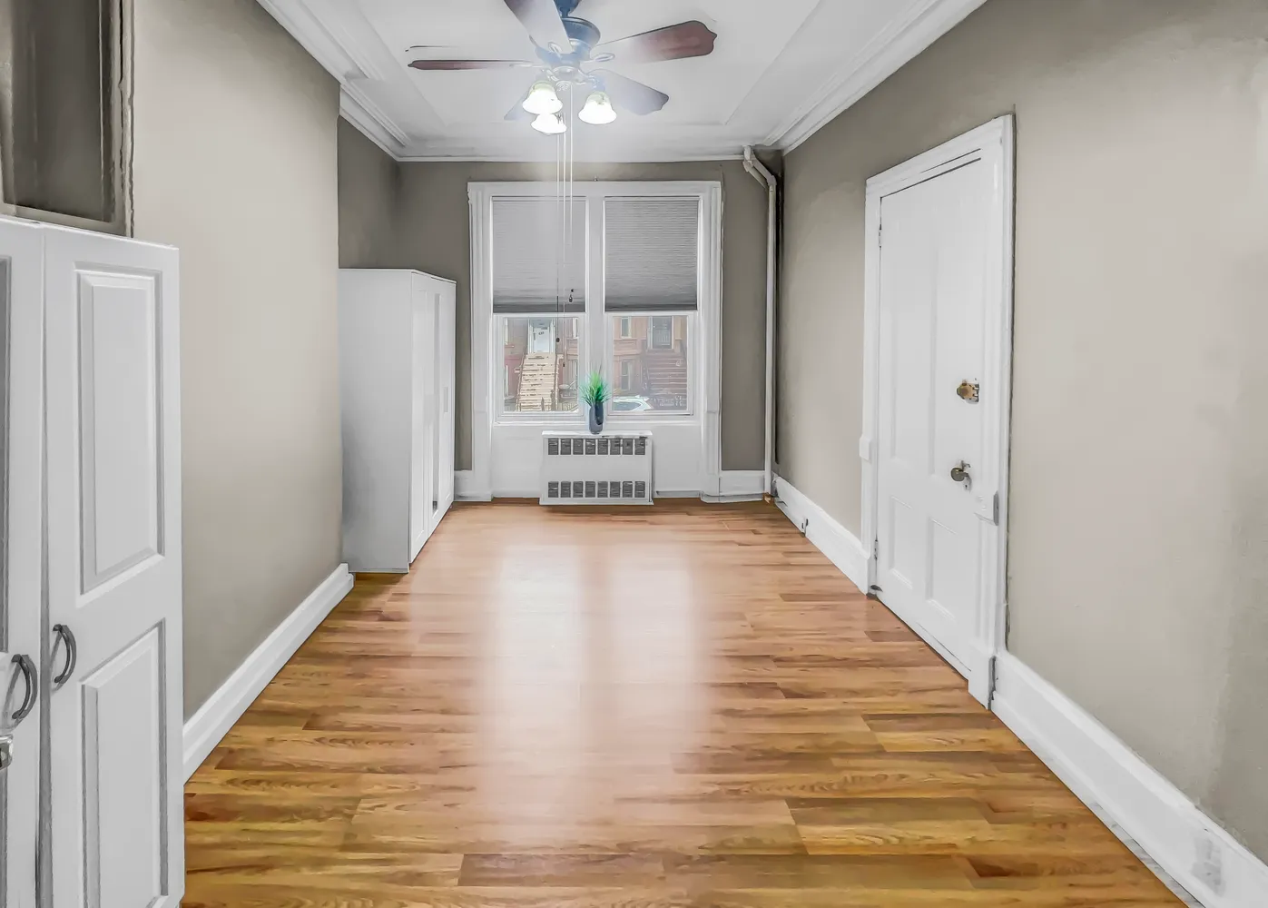 a view of a hallway with wooden floor and staircase