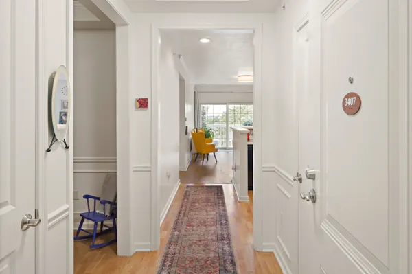 a view of a hallway with wooden floor and staircase