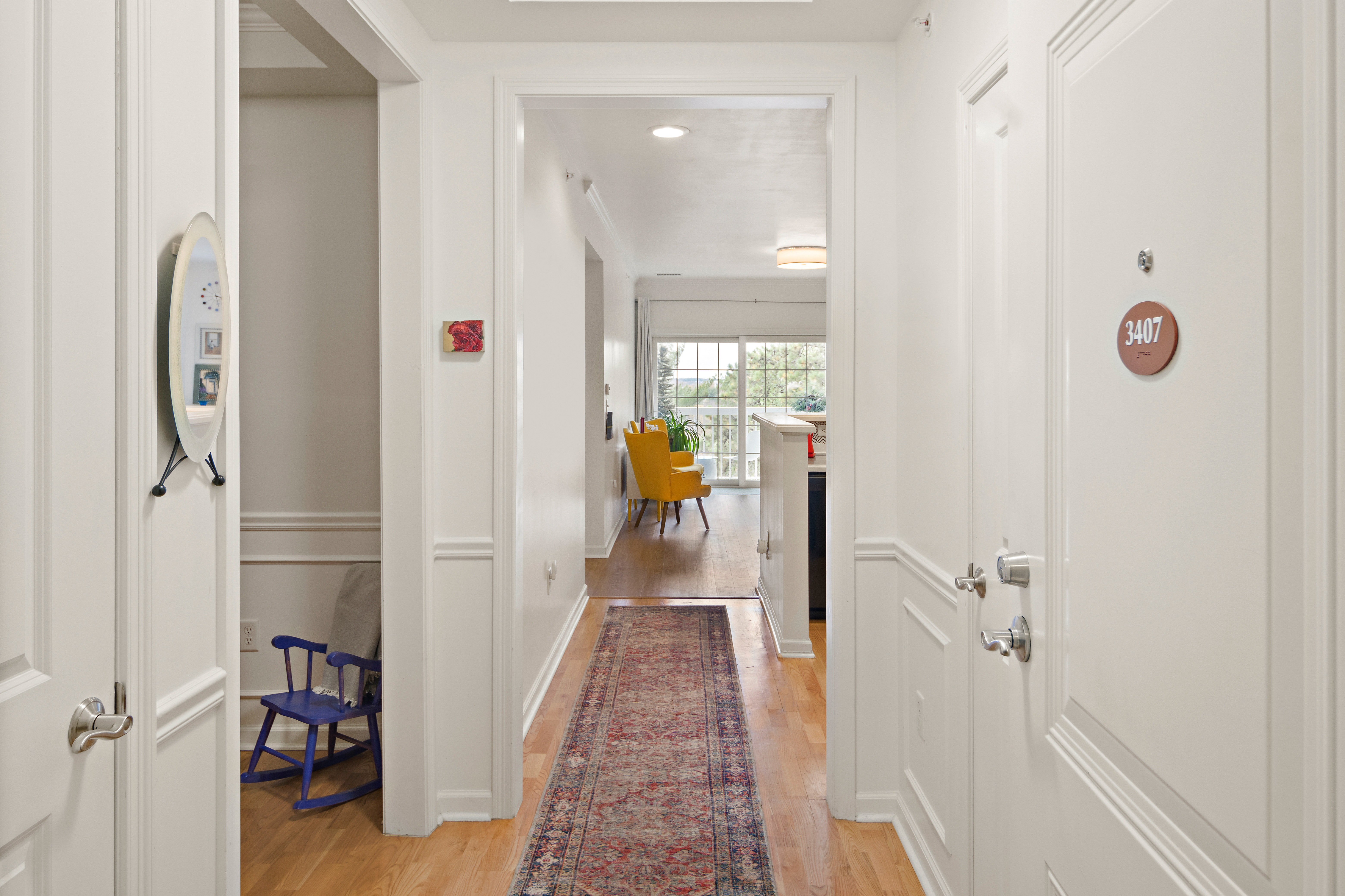 107 Clocktower Drive, Unit 407 Waltham, MA 02452 - Photo 8 of 19 a view of a hallway with wooden floor and staircase