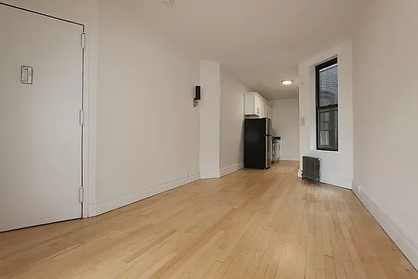 112 East 97th Street, Unit 3E Manhattan, NY 10029 - Photo 2 of 4 a view of a room with a refrigerator and a sink