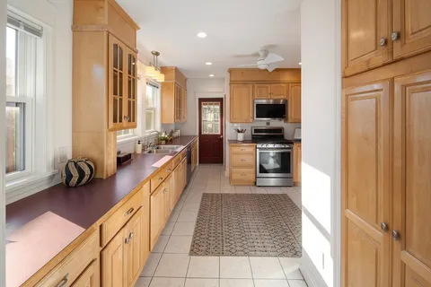a view of a kitchen with a sink and cabinets