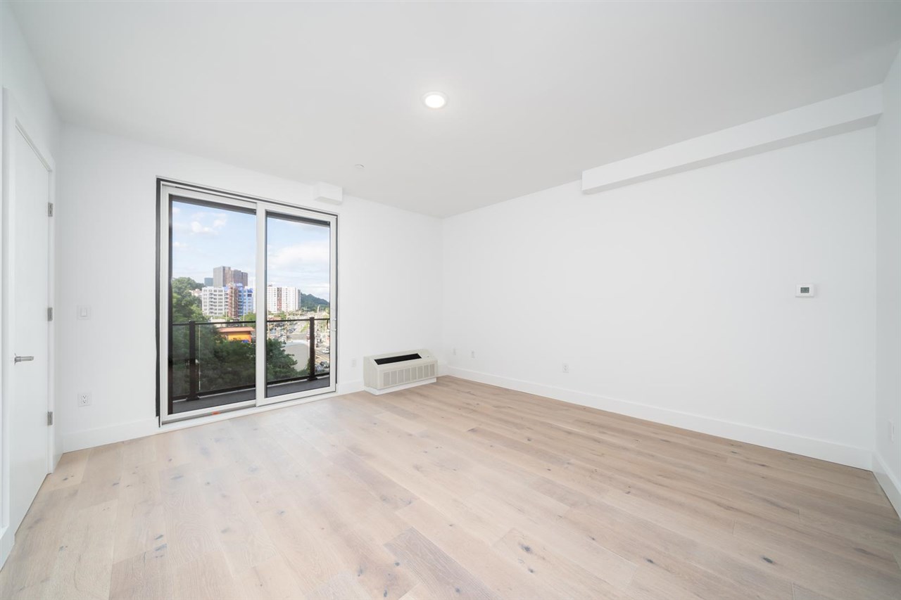 8621 River Road, Unit 6D North Bergen, NJ 07047 - Photo 15 of 36 an empty room with wooden floor and windows