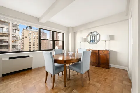 a dining room with furniture and window