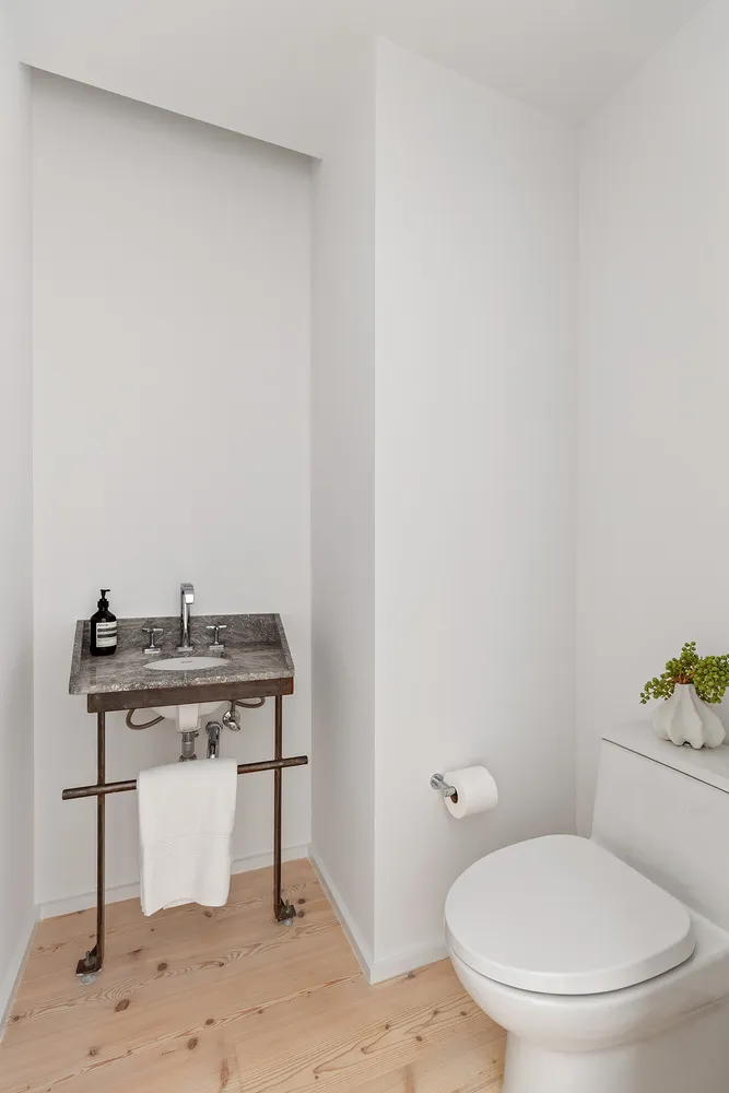 a bathroom with a toilet a sink and a mirror