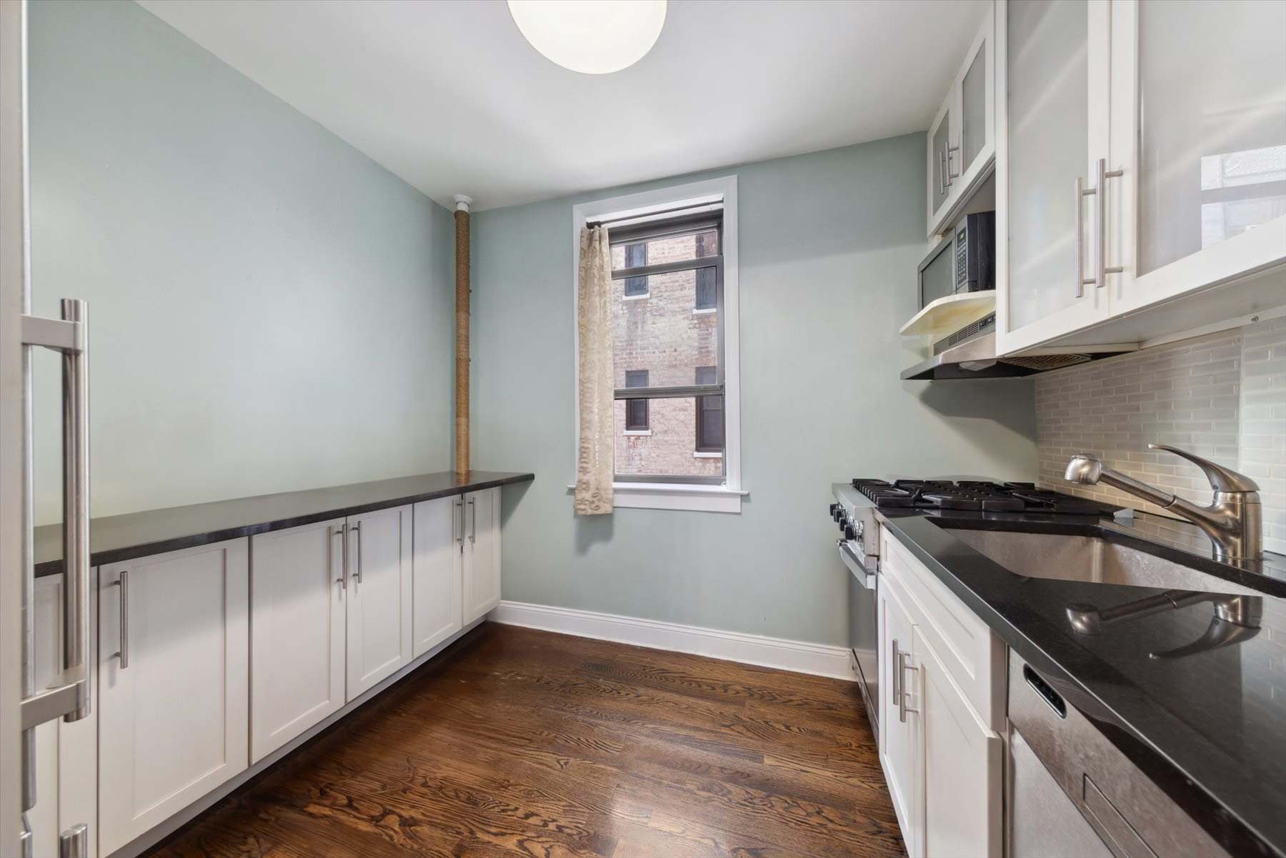 221 East 78th Street, Unit 4J Manhattan, NY 10075 - Photo 3 of 7 a kitchen that has a sink and a stove
