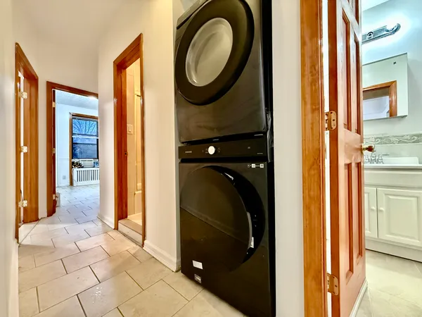 a view of a bathroom with washing machine and a shower