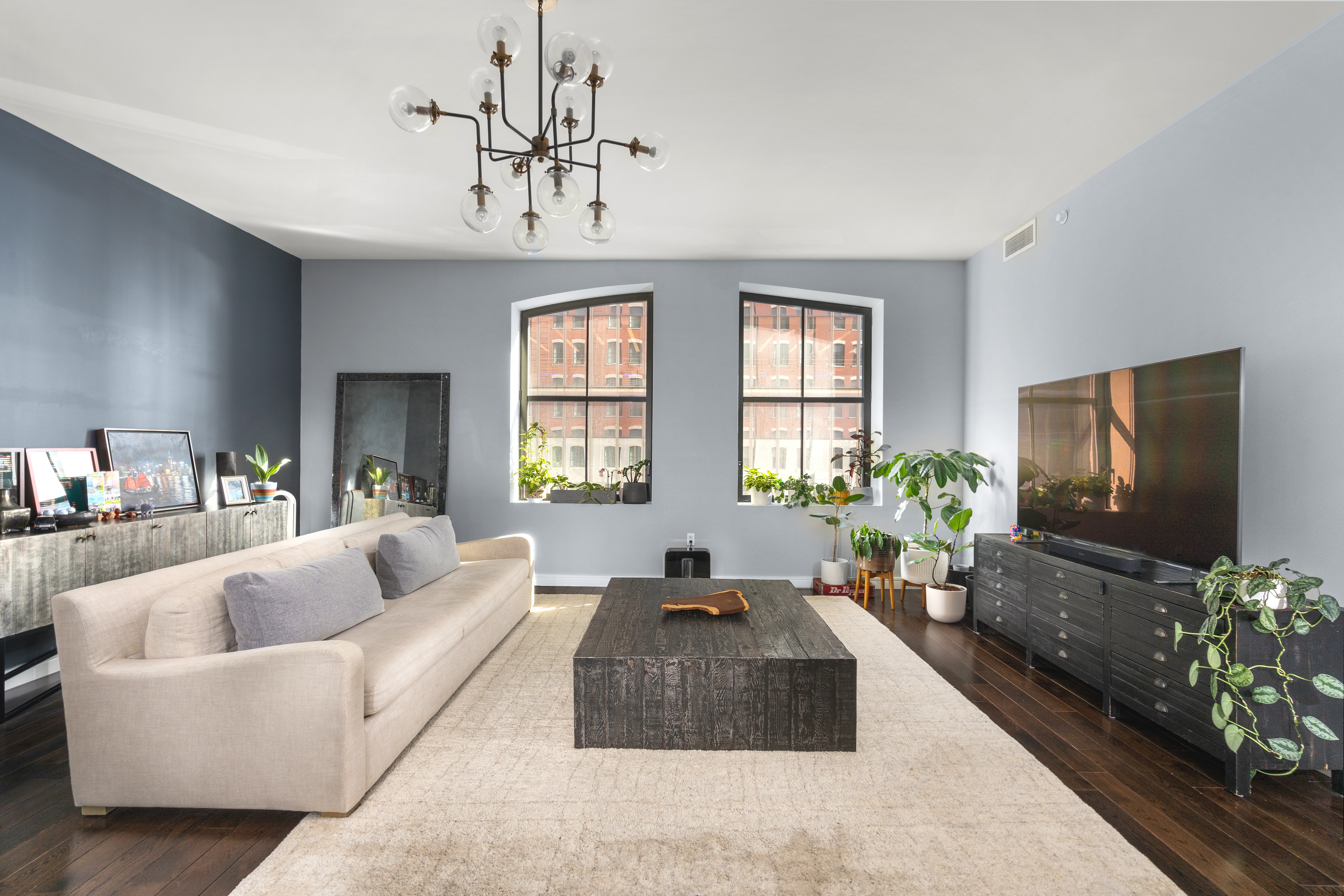 250 West Street, Unit 3F Manhattan, NY 10013 - Photo 1 of 11 a living room with fireplace furniture and a flat screen tv