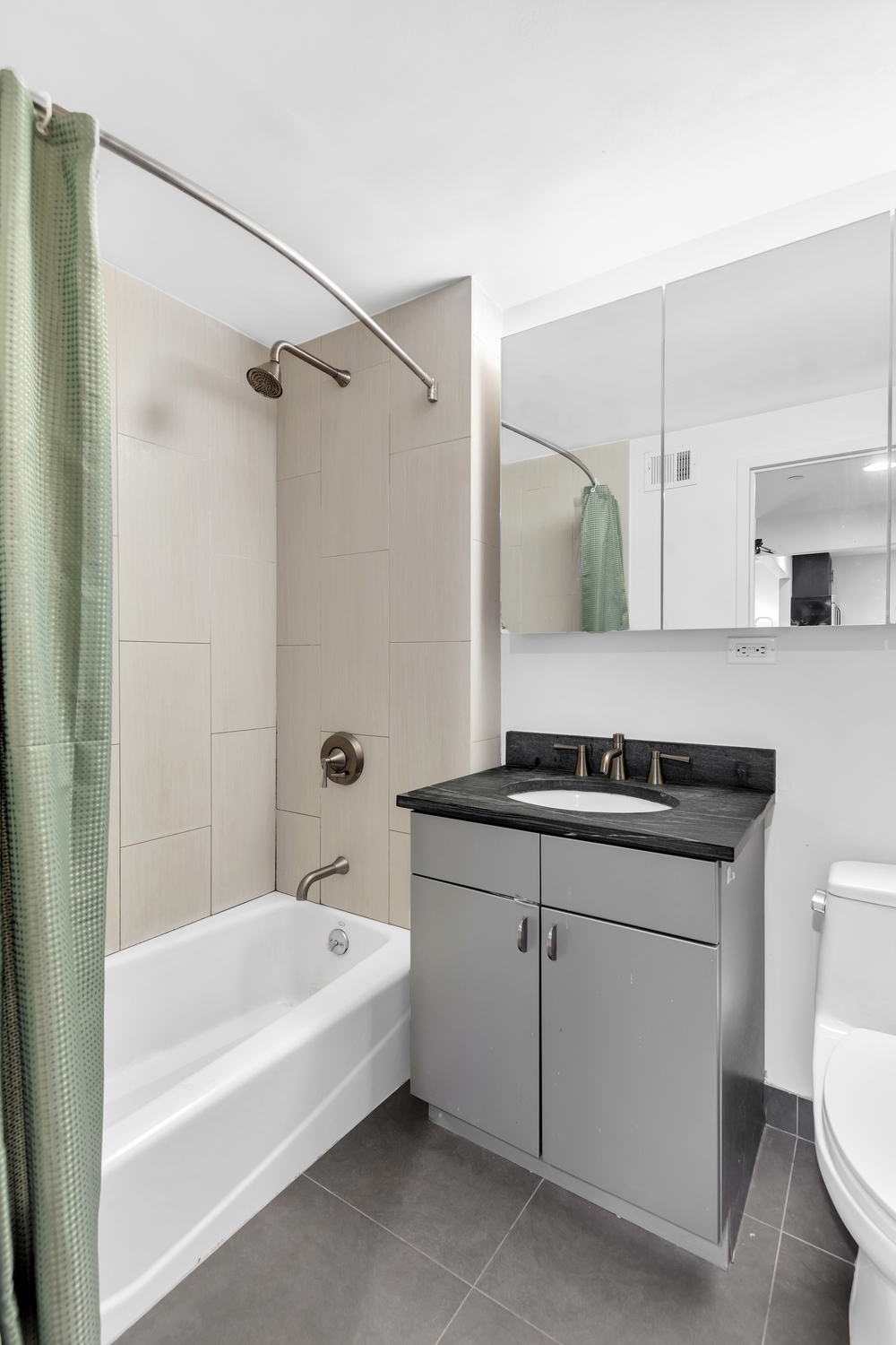 1810 3rd Avenue, Unit A7C Manhattan, NY 10029 - Photo 5 of 12 a bathroom with a sink a toilet and shower
