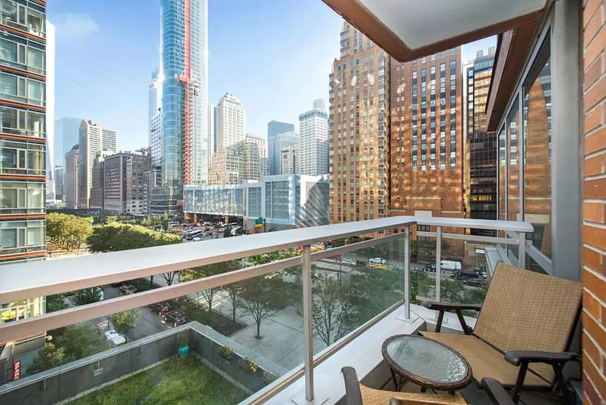 30 West Street, Unit 6B Manhattan, NY 10004 - Photo 4 of 13 a city view from a balcony with chairs