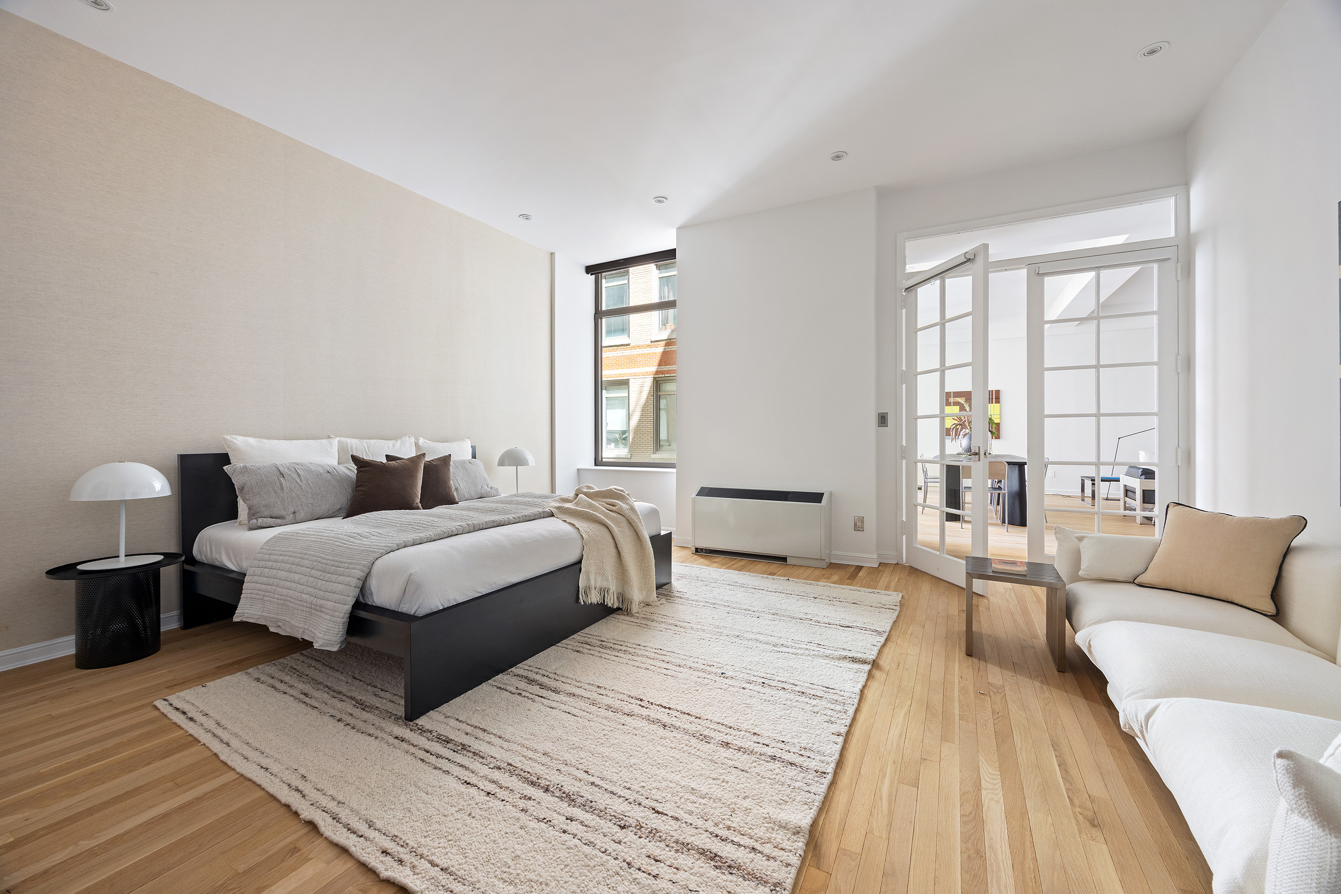 252 7th Avenue, Unit 9R Manhattan, NY 10001 - Photo 14 of 23 a spacious bedroom with a bed and a couch