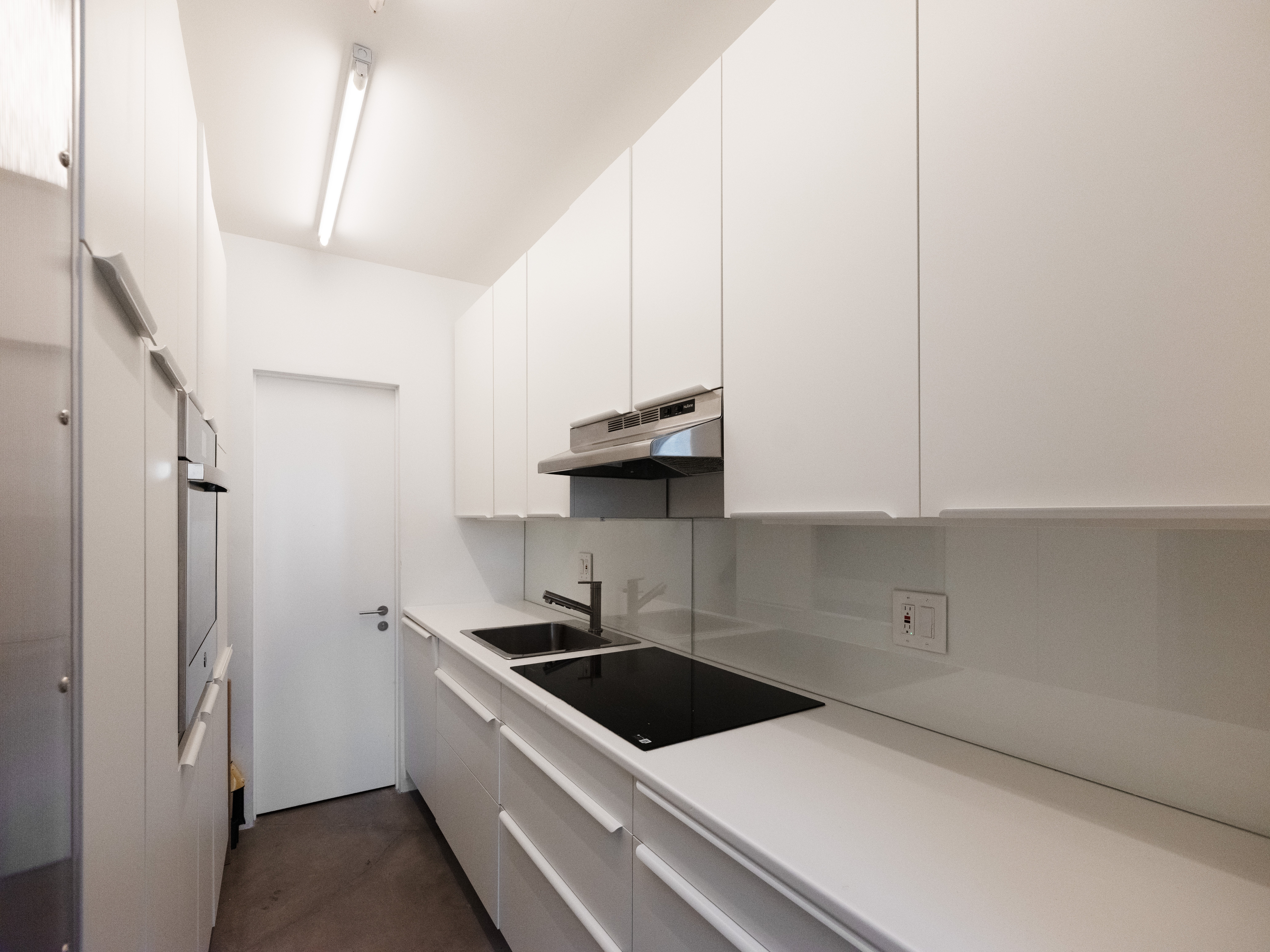 186 East 2nd Street, Unit 16 Manhattan, NY 10009 - Photo 4 of 17 a kitchen with stainless steel appliances a white stove top oven and cabinets