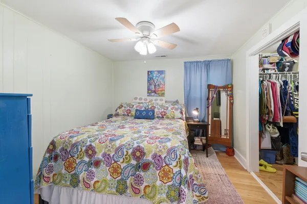 a bedroom with a bed and a chandelier