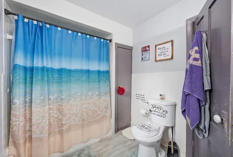 a bathroom with a toilet and a shower