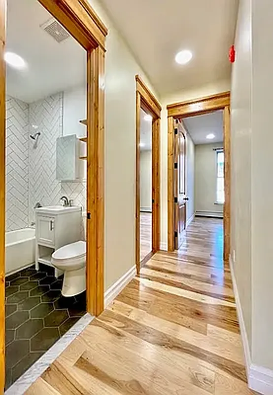 1120 Greene Avenue, Unit 1 Brooklyn, NY 11221 - Photo 13 of 13 a bedroom with a bed and a view of bathroom