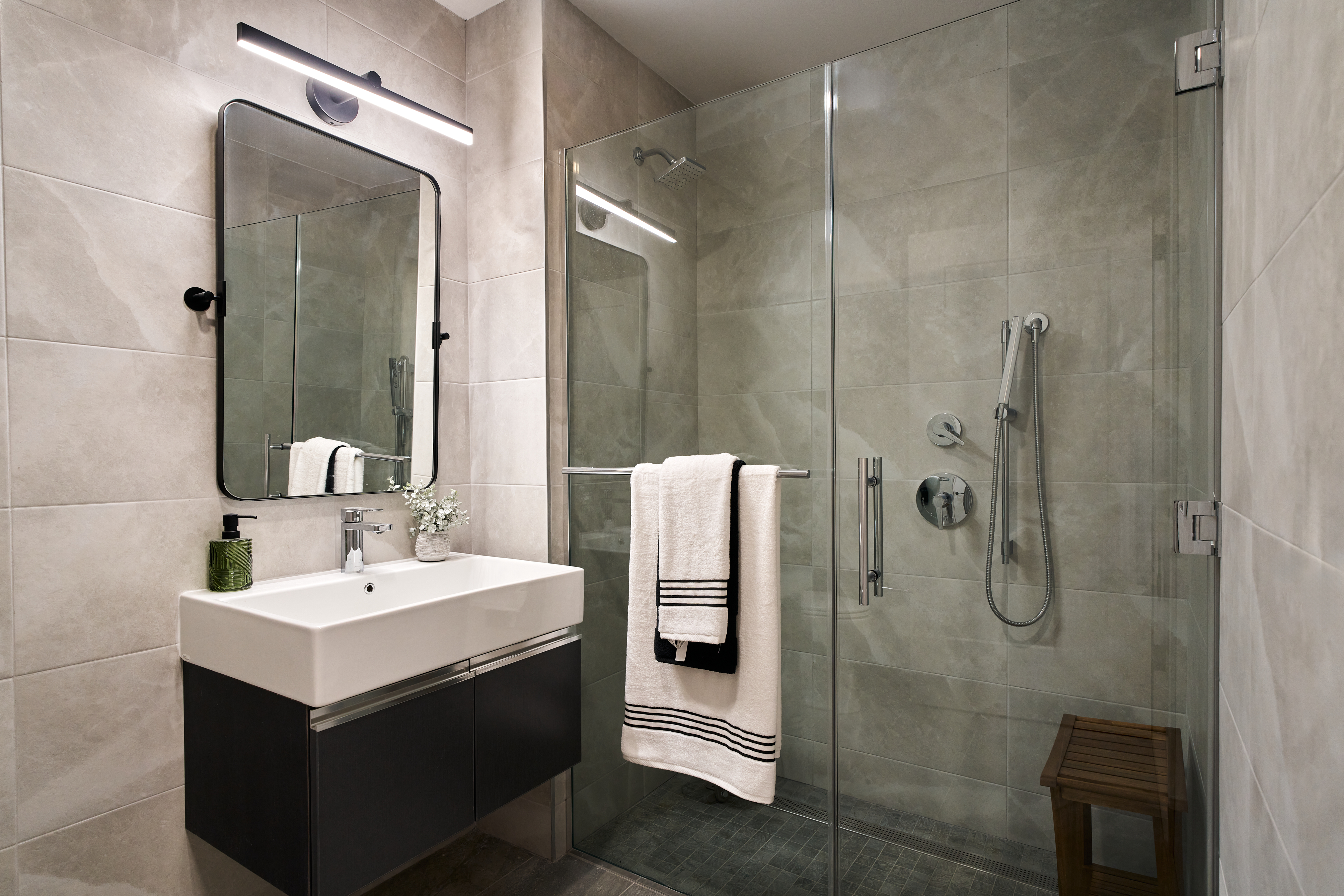 4414 Douglaston Parkway, Unit 6C Queens, NY 11363 - Photo 6 of 14 a bathroom with a sink mirror and shower