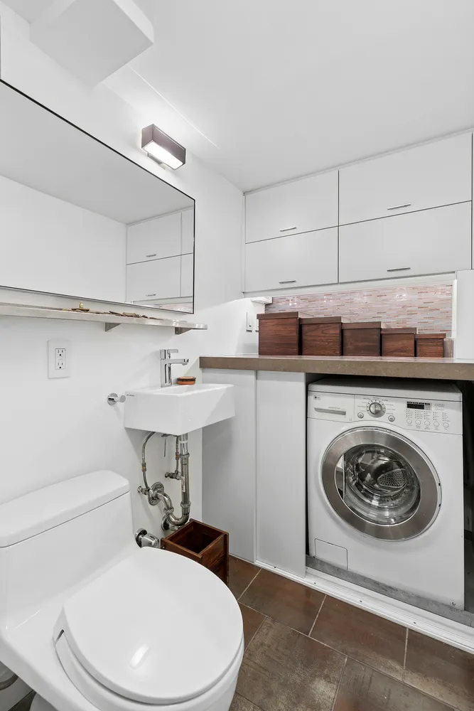 a utility room with sink dryer and washer