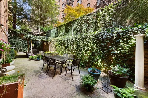 a backyard of a house with table and chairs