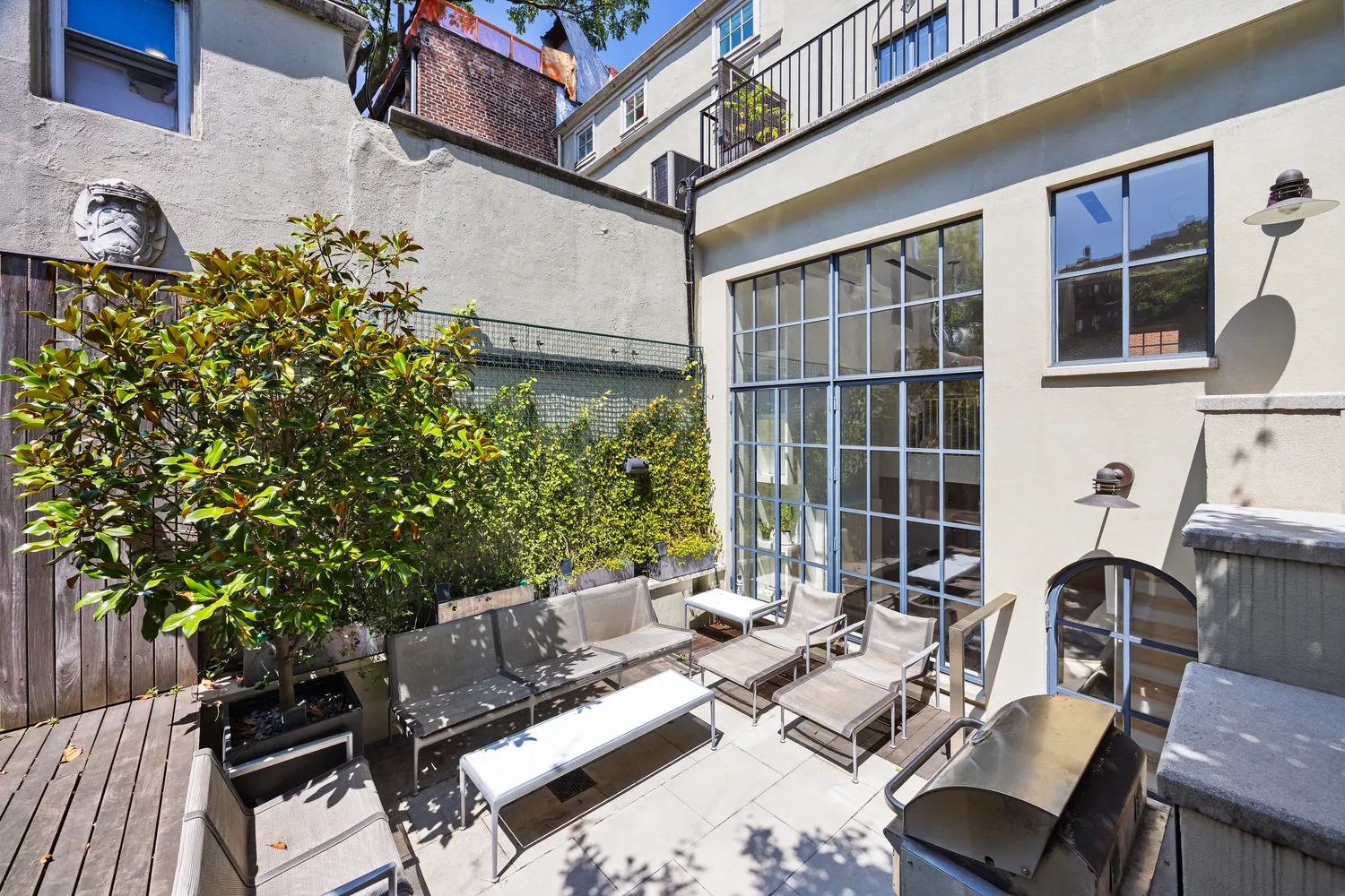 a view of a patio with couches table and chairs and potted plants