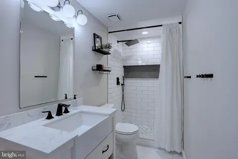 a bathroom with a sink toilet and shower